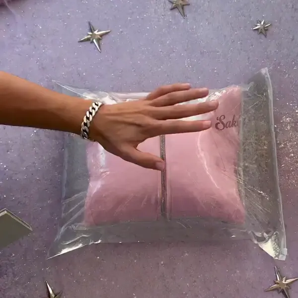 Unboxing: the vacuum-sealed pink hoodie being cut out of its package